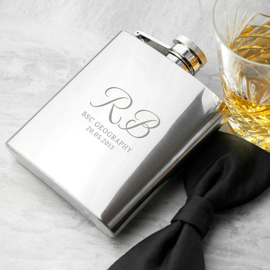 A polished stainless steel 6oz graduation hip flask custom-engraved with a graduate's initials, course name, and graduation date.