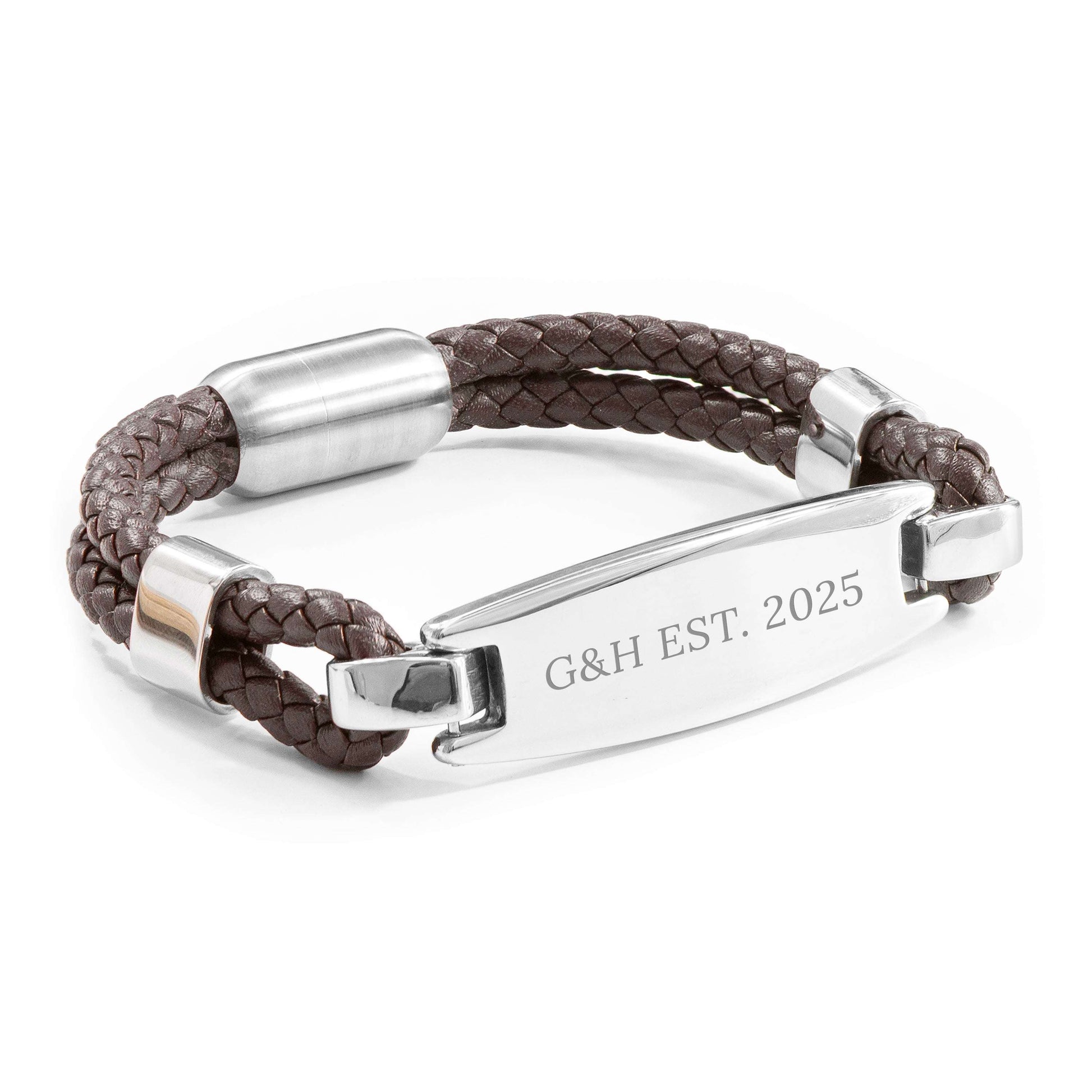 Brown braided leather bracelet with silver clasp and engraved tag on a white background