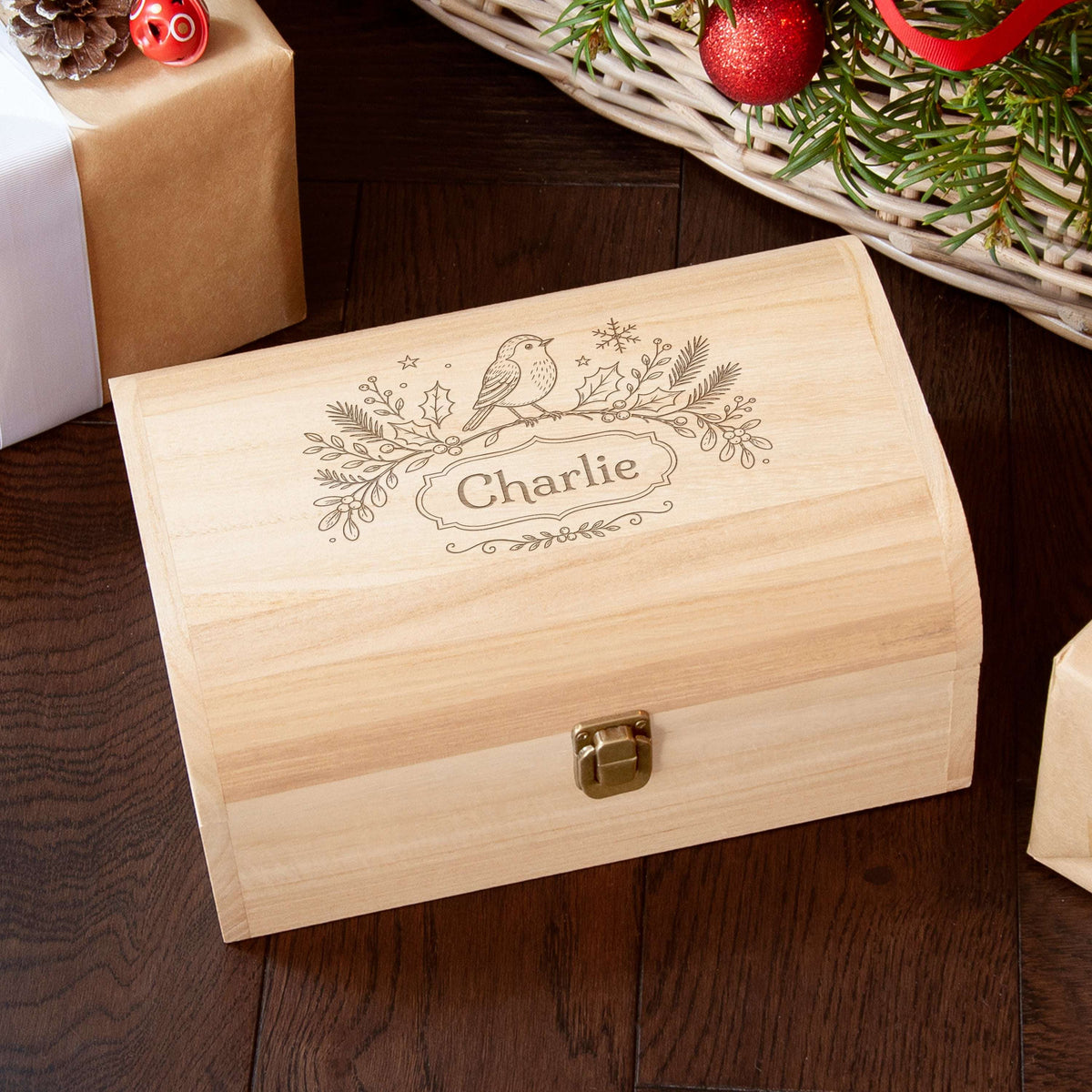 A personalized light wood gift box with a brass clasp, engraved with a bird and custom name 'Charlie',