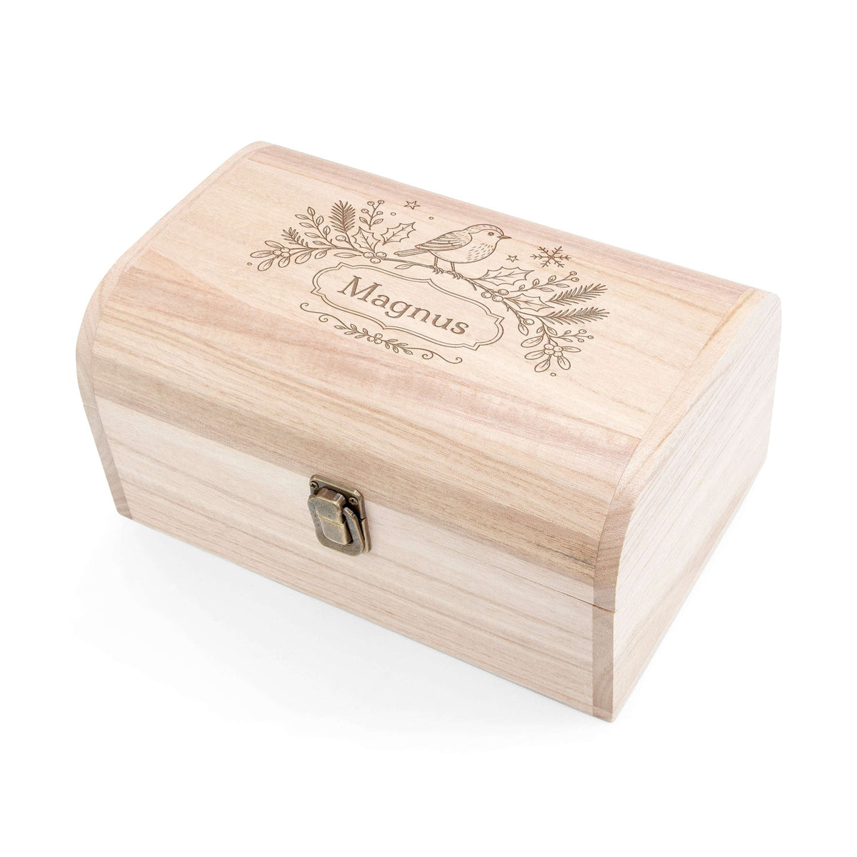 A light natural wood keepsake box with a curved lid, featuring an engraved bird and pine branch design with the name 'Magnus' on the lid, and a small metal clasp on the front, shown on a white background.