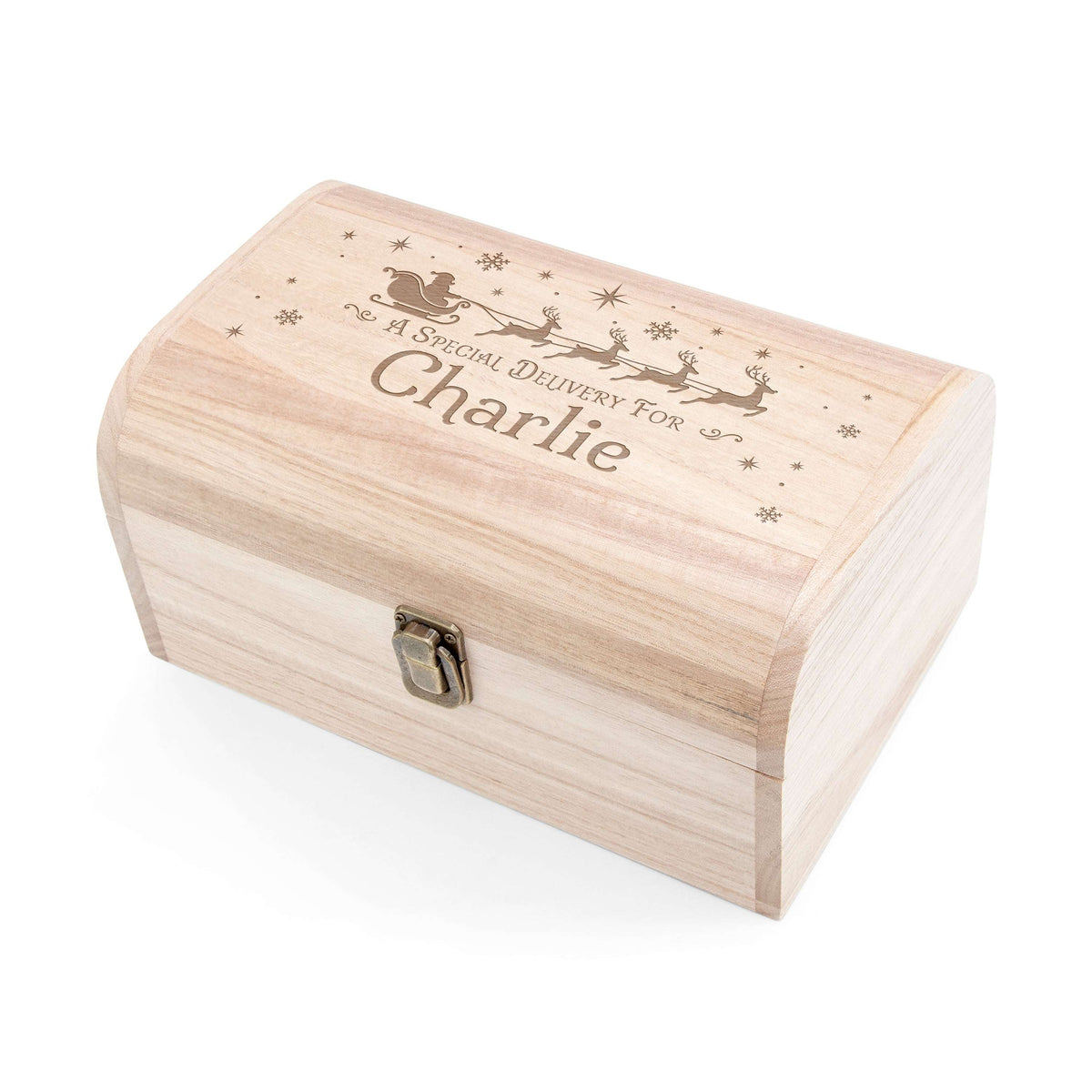 A personalized light wood Christmas gift box with a metal clasp, featuring an engraved Santa Claus scene and the childs name engraved on the lid,