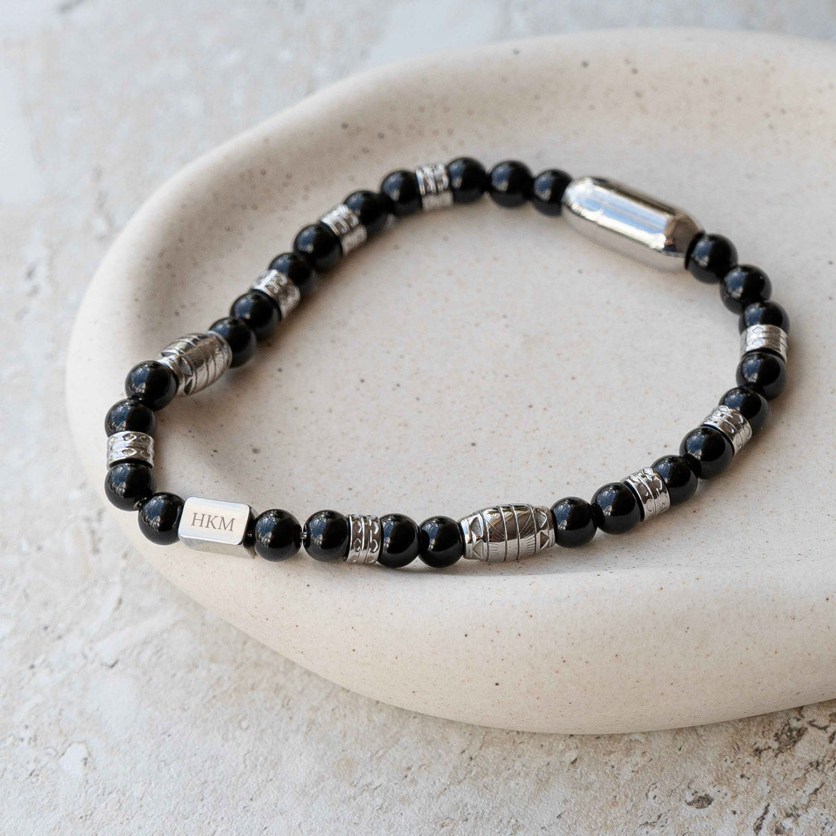 A Personalized Onyx Gemstone Bead Bracelet with engraved silver tag 