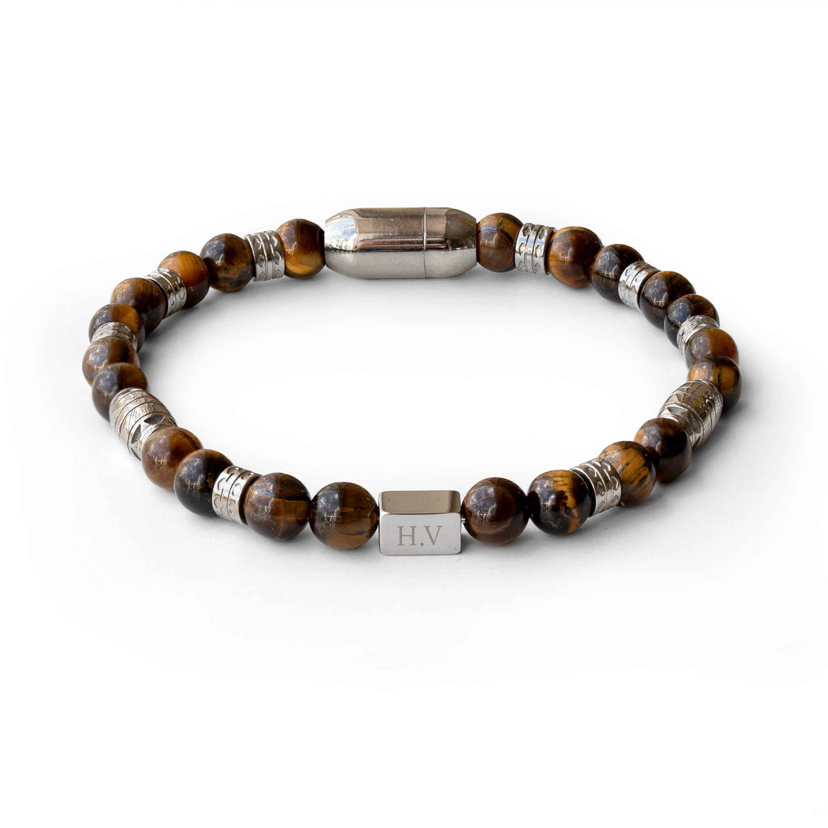 A beaded stretch bracelet featuring round brown and black tiger's eye beads, textured silver metal spacers, and a central silver rectangular charm engraved with initials.