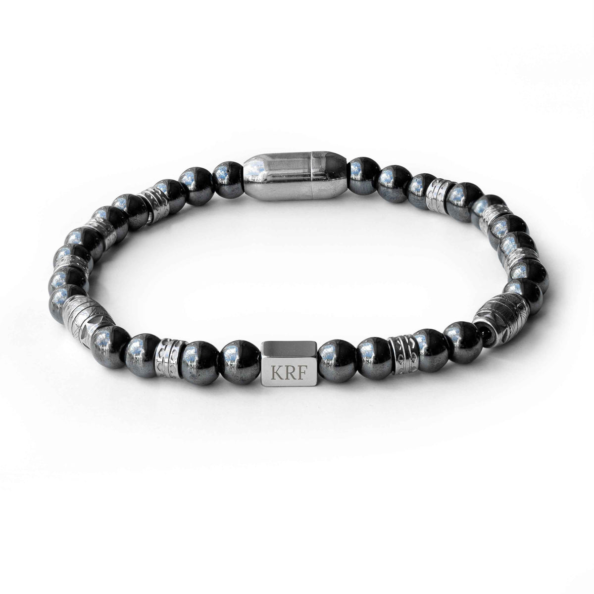 A beaded men's bracelet featuring dark gray metallic beads, silver-toned spacer beads, and a central silver rectangular charm engraved with initials