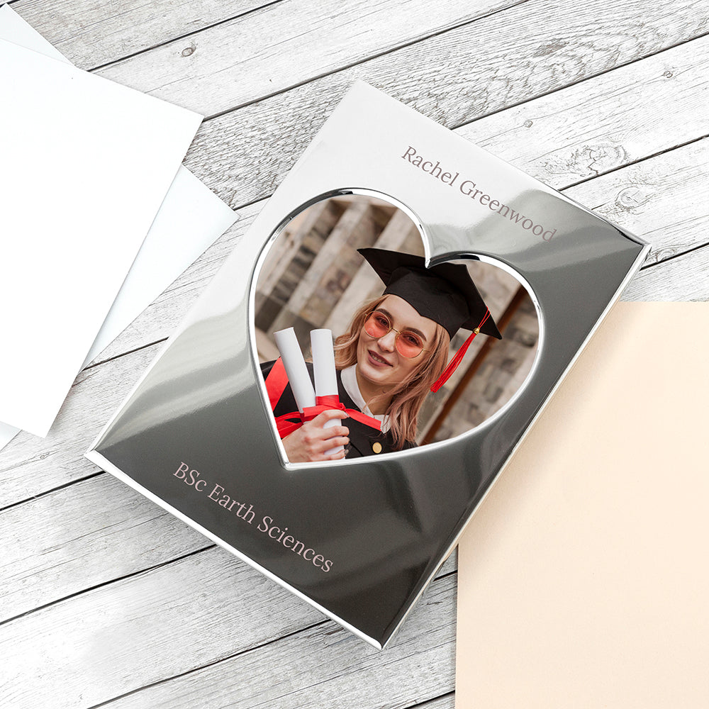 Graduation-themed photo frame with a cutout of a person in a graduation cap and gown