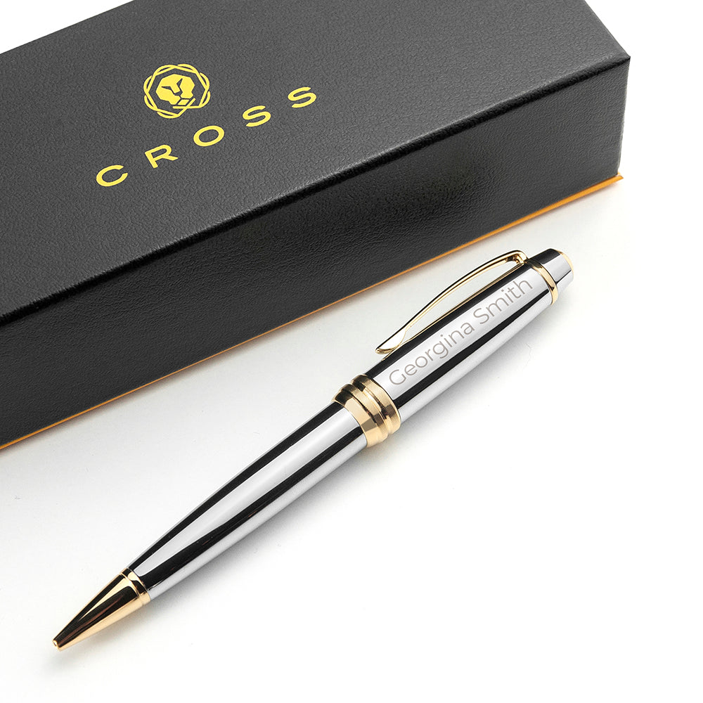 Close-up of a personalized cross medallist pen with silver and gold accents