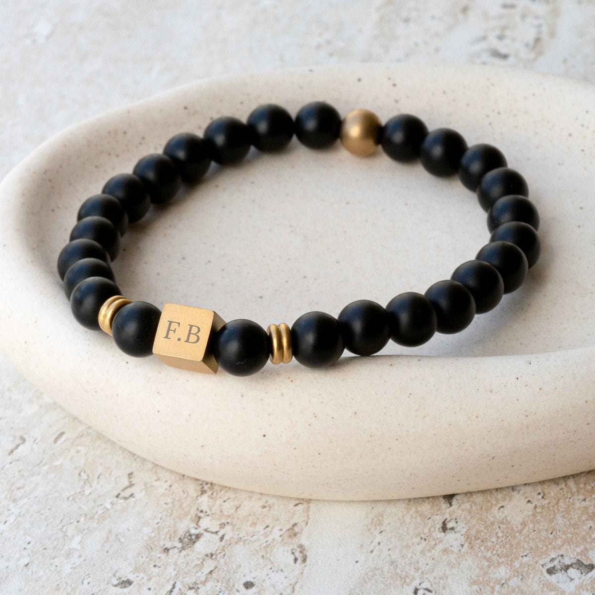 Personalized Onyx Bead Bracelet with a gold cube charm engraved with initials,