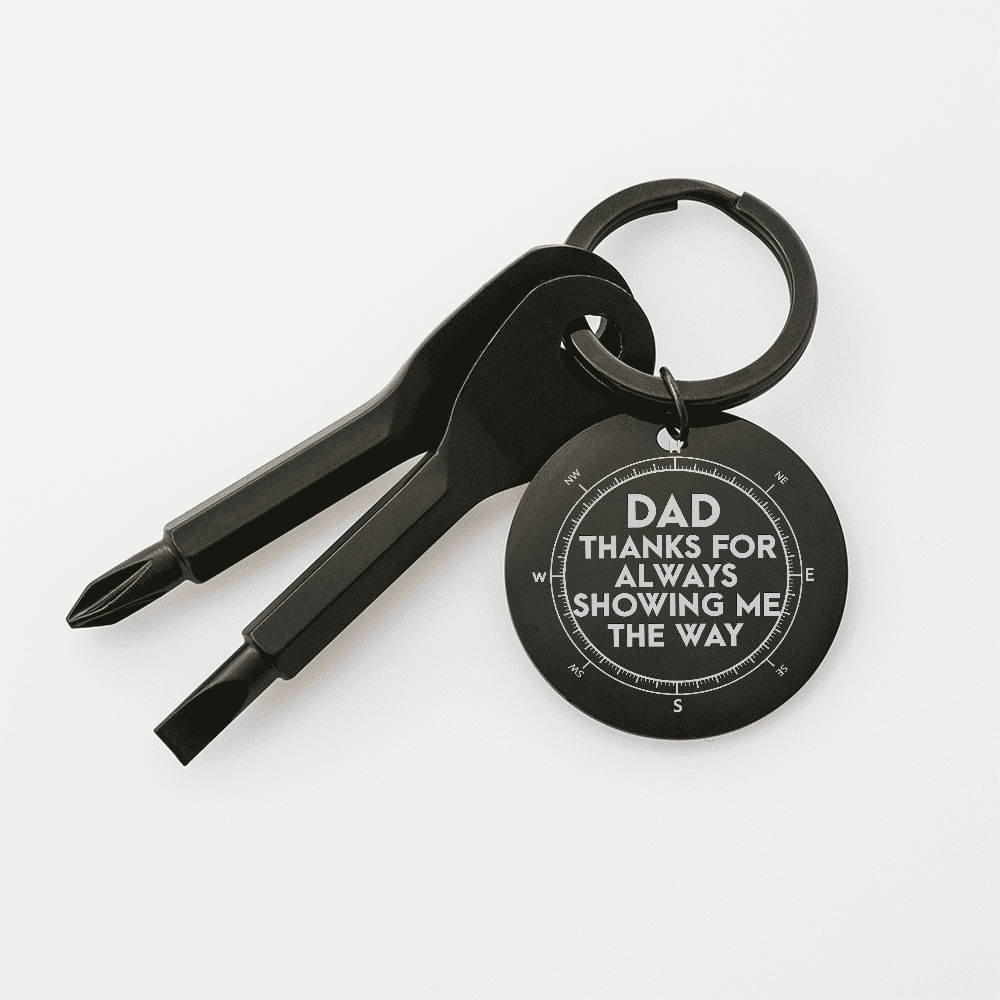 Black keychain with tool bits and engraved message on a white background