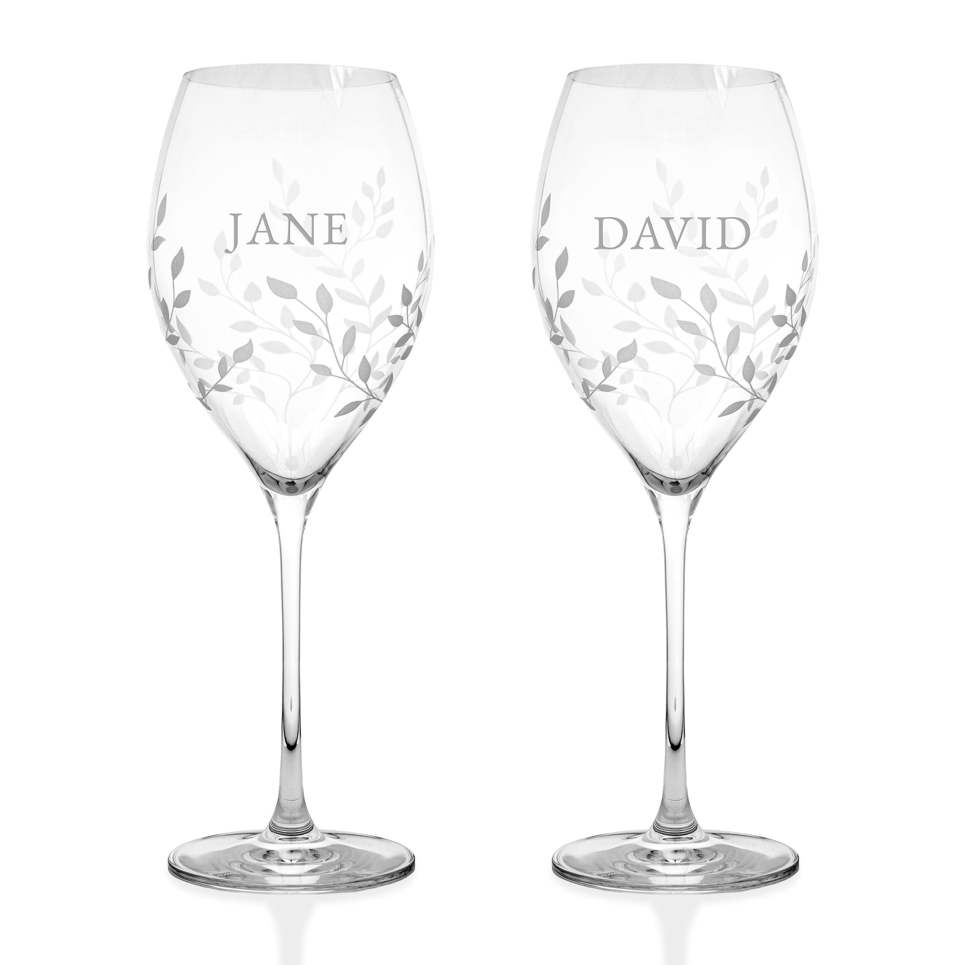 Two clear wine glasses with etched leaf patterns and personalized names 'JANE' and 'DAVID' on a white background.
