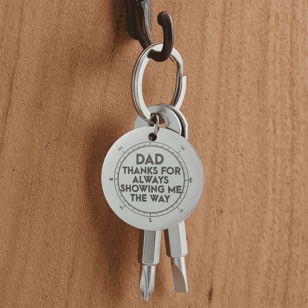 screwdriver-Keychain with engraved message on a wooden surface